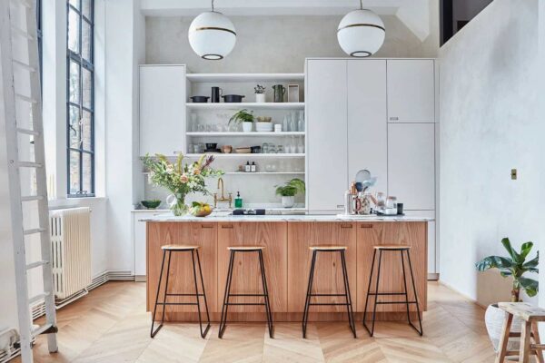 white kitchen with brown wooden island