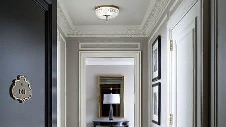 white POP false ceiling with cornices for lobby with black and white walls and check-patterned flooring