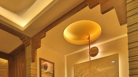 pooja room design with cove lighting and pendant lights