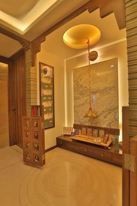 pooja room design with cove lighting and pendant lights