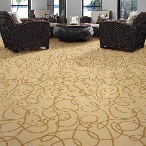 Carpet floors in neutral shade with dark abstract patterns and coffee colour furniture