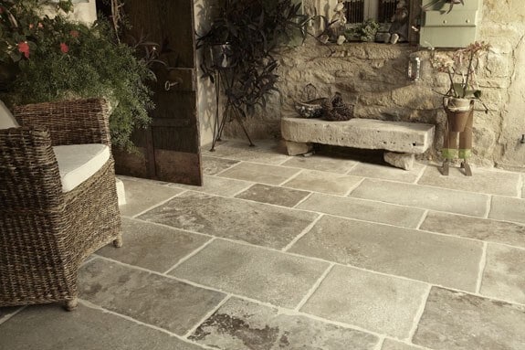 stone flooring for outdoor area with stone cladding and rustic furniture