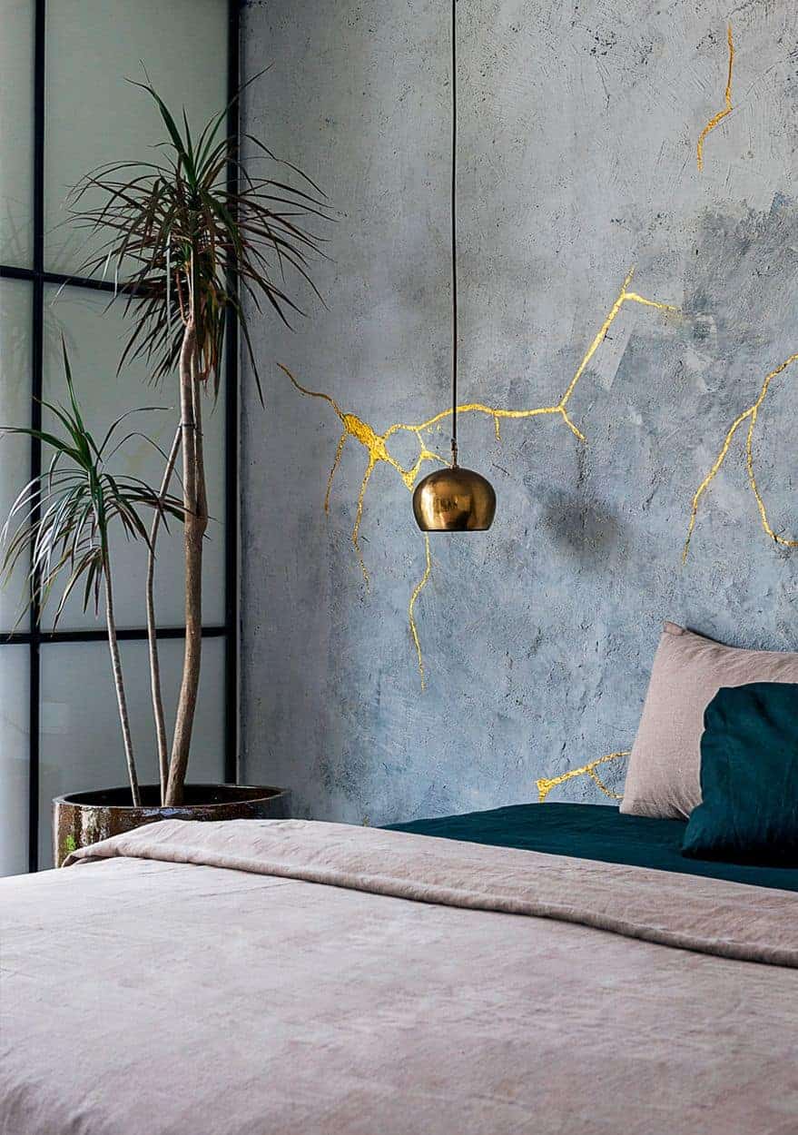 golden lighting design on blue walls of bedroom