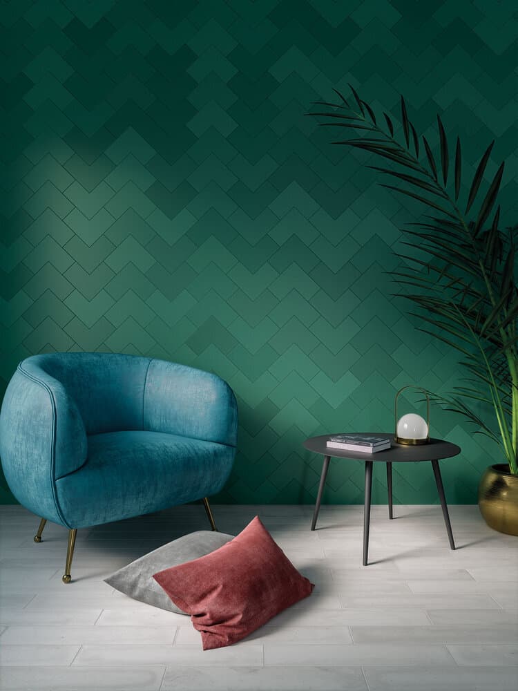 green wallpaper behind a blue sofa