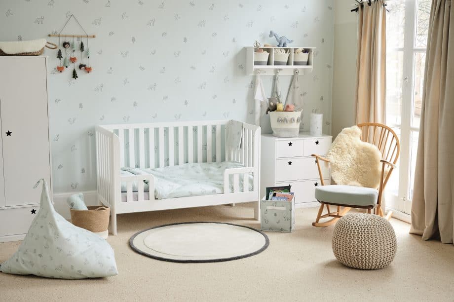 white painted cot with vertical bars on all sides