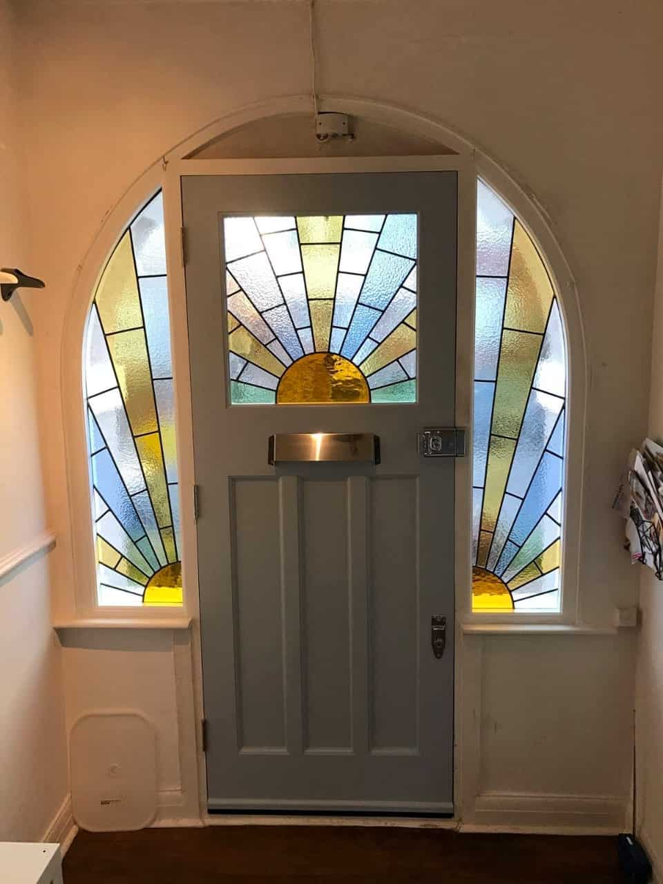 white door with stained glass panel and sidelights