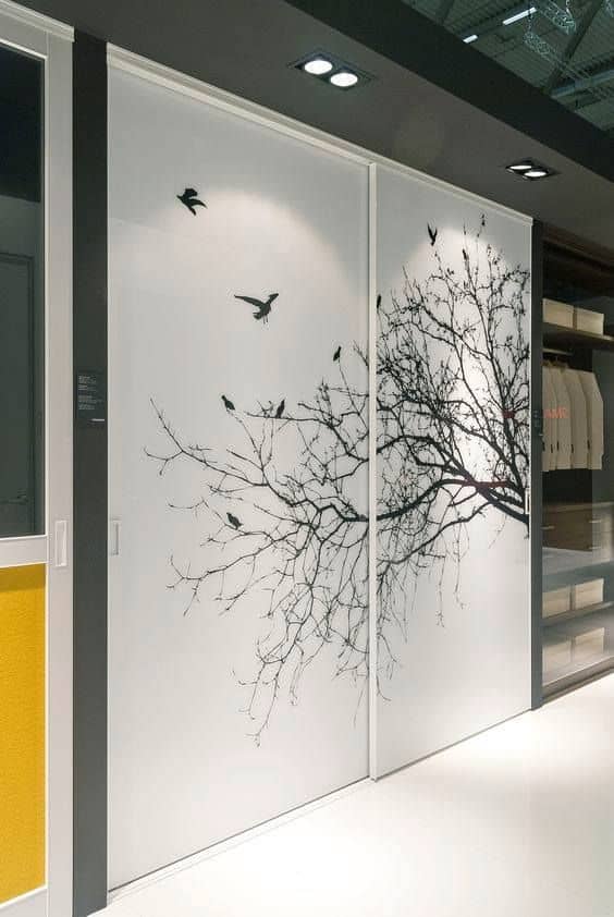 tree branches and birds wallpaper on a white closet