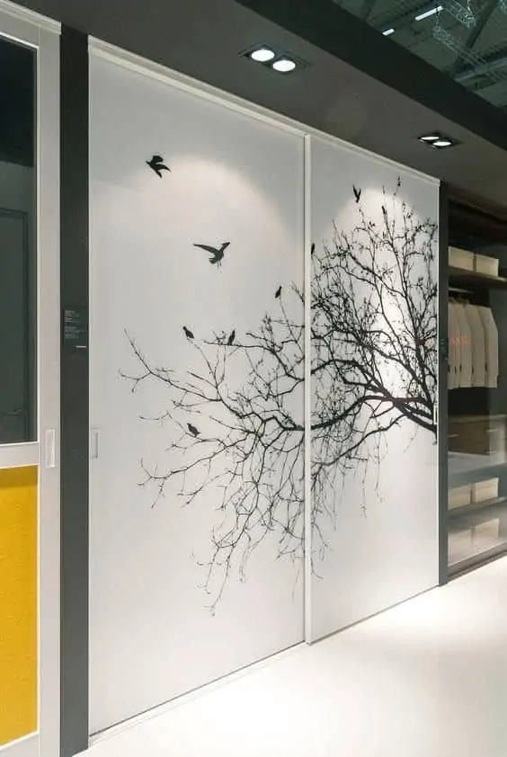 tree branches and birds wallpaper on a white closet