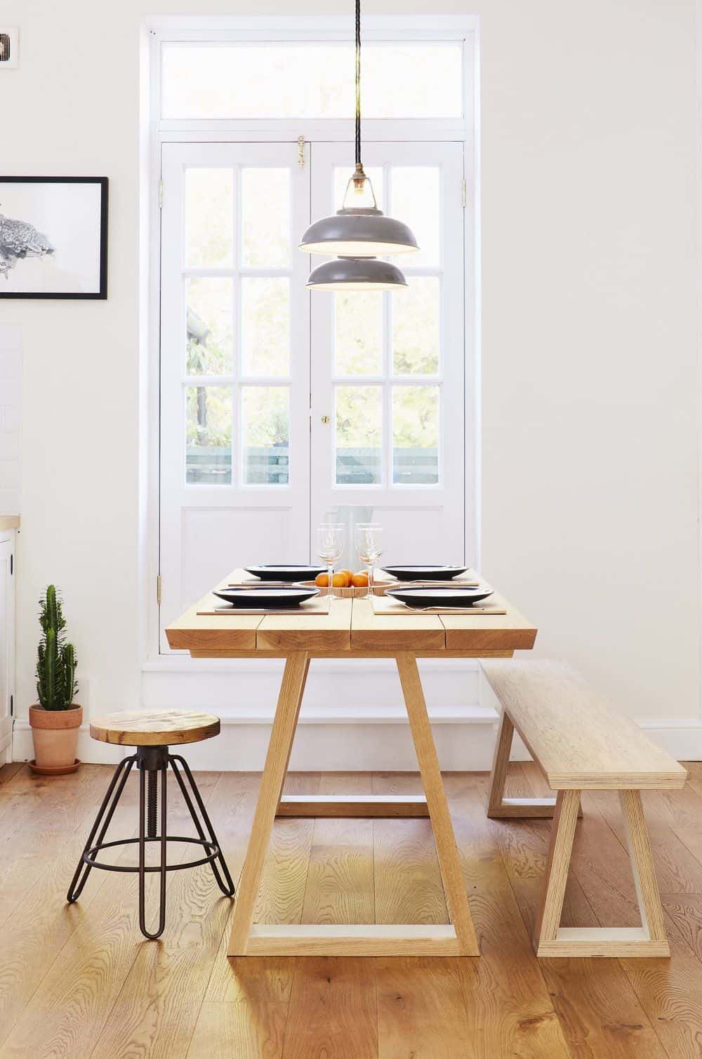 bespoke plywood table for dining in front of a white glass door