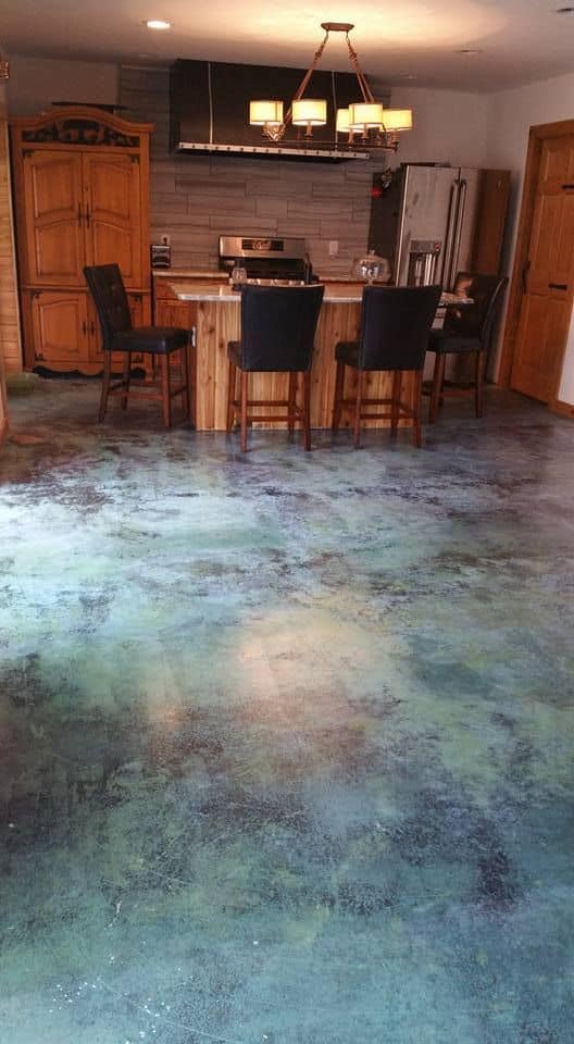 green epoxy flooring for kitchen with black chairs and wooden furniture