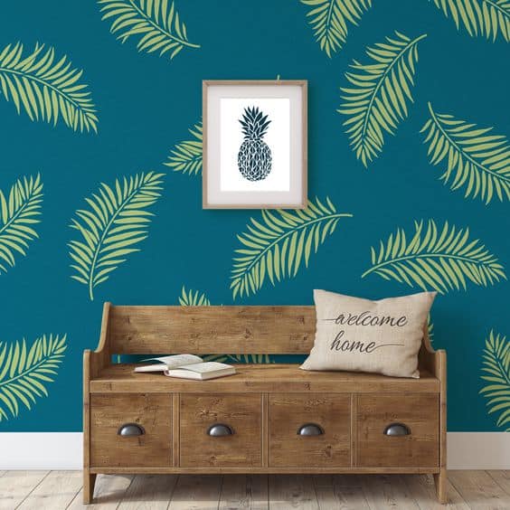 green palm leaves stenciled on a blue wall paint design