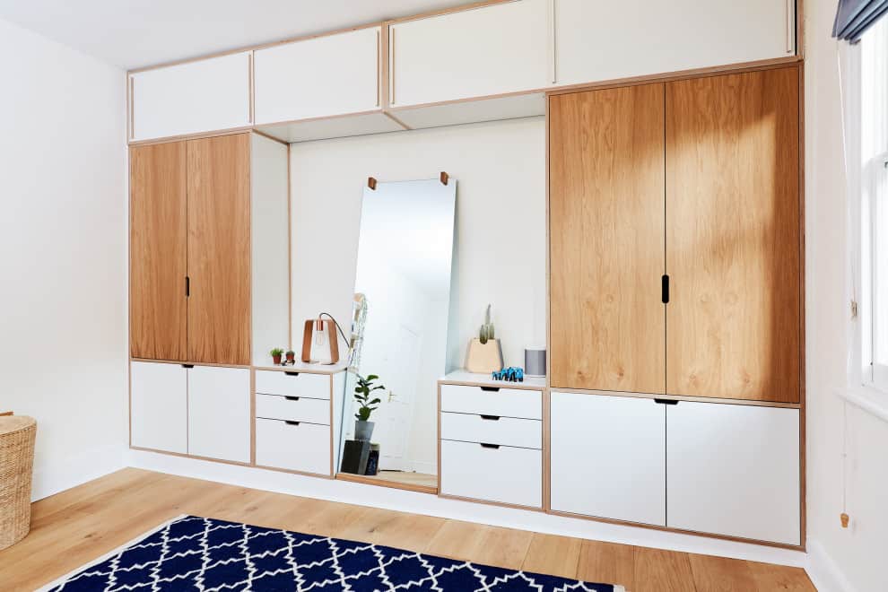 White and light brown wardrobe with a dresser and mirror