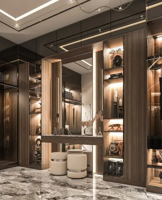 huge walk-in closet with a dressing table set up and stools