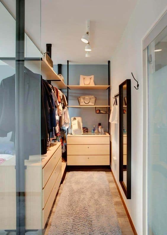 Light blue and white walk-in wardrobe designs with a wall mirror on one side