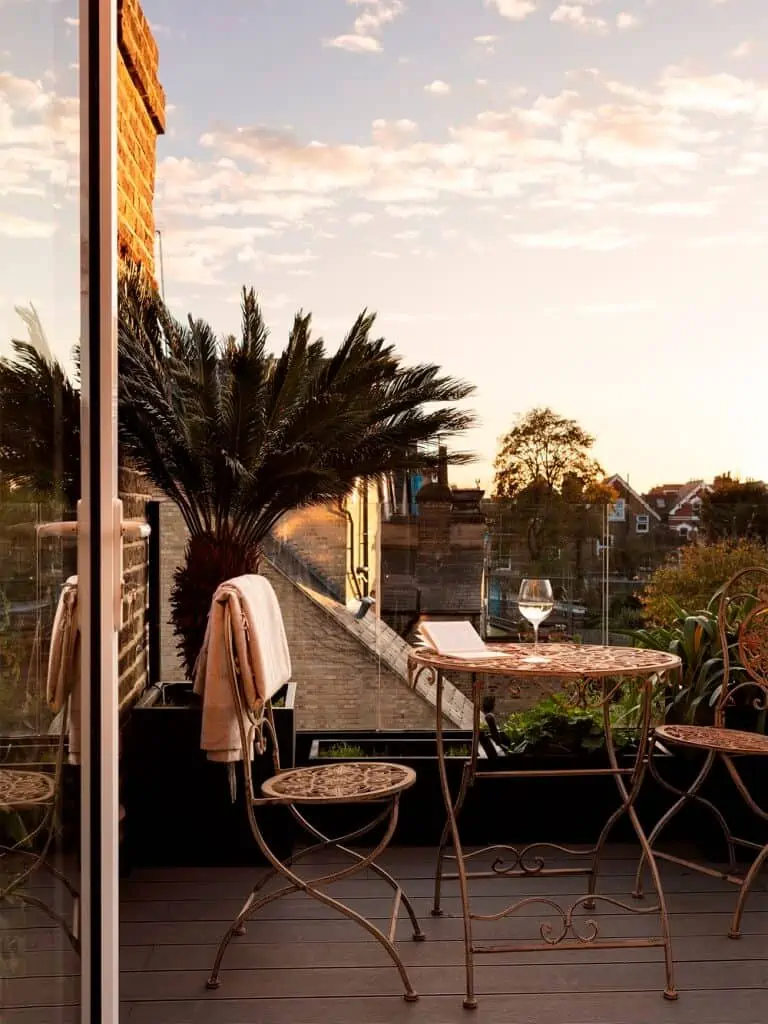 rooftop seating area with a round table and two chairs