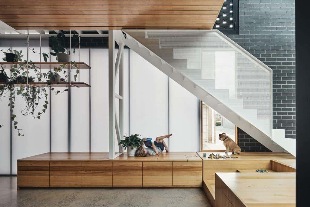 modern staircase beside black brick wall, home design interior with wooden ceiling and a wood seating deck
