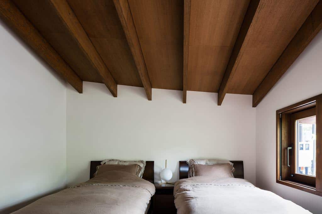 home design interior with wooden ceiling and two beds