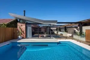 home design exterior with a swimming pool and huge glass window