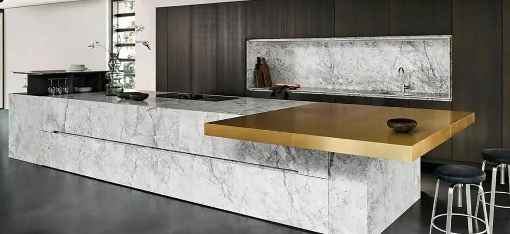 Designer kitchen in white and gold colours with island, cabinet and cupboard