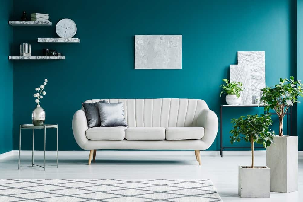  teal colored living room with neutral sofa