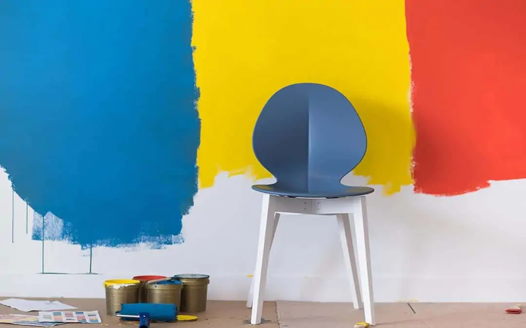 blue, yellow, and red paint on a white wall