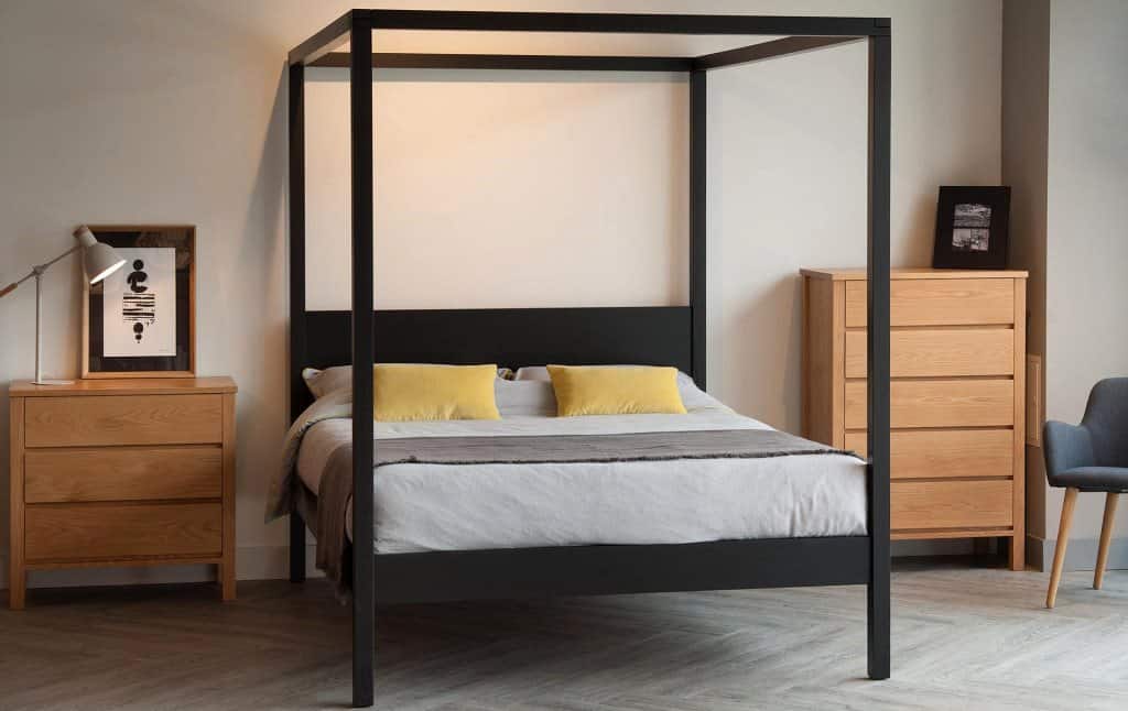 Contemporary four poster double bed in black orchid wood with bedside table