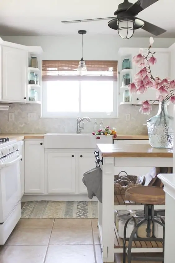 Contrast your white kitchen with a black fan with light.