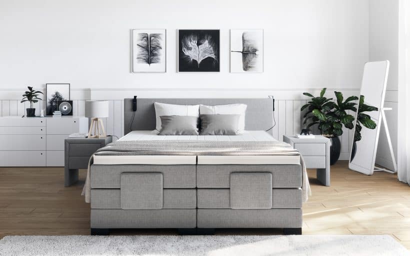 grey bed design with storage space beneath the mattress panel with bedside table in same material