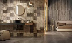 grey and golden wall tiles and concrete floor tiles in a bathroom