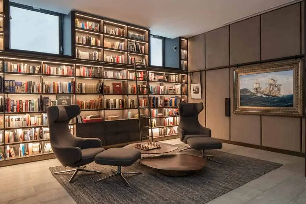 bookshelf on a living roomwall with concealed accent lights all over