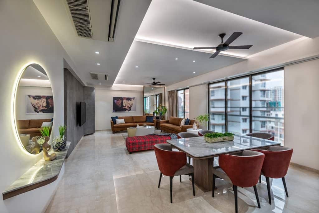 white dining room with a dining table, mirror, fan and living room view