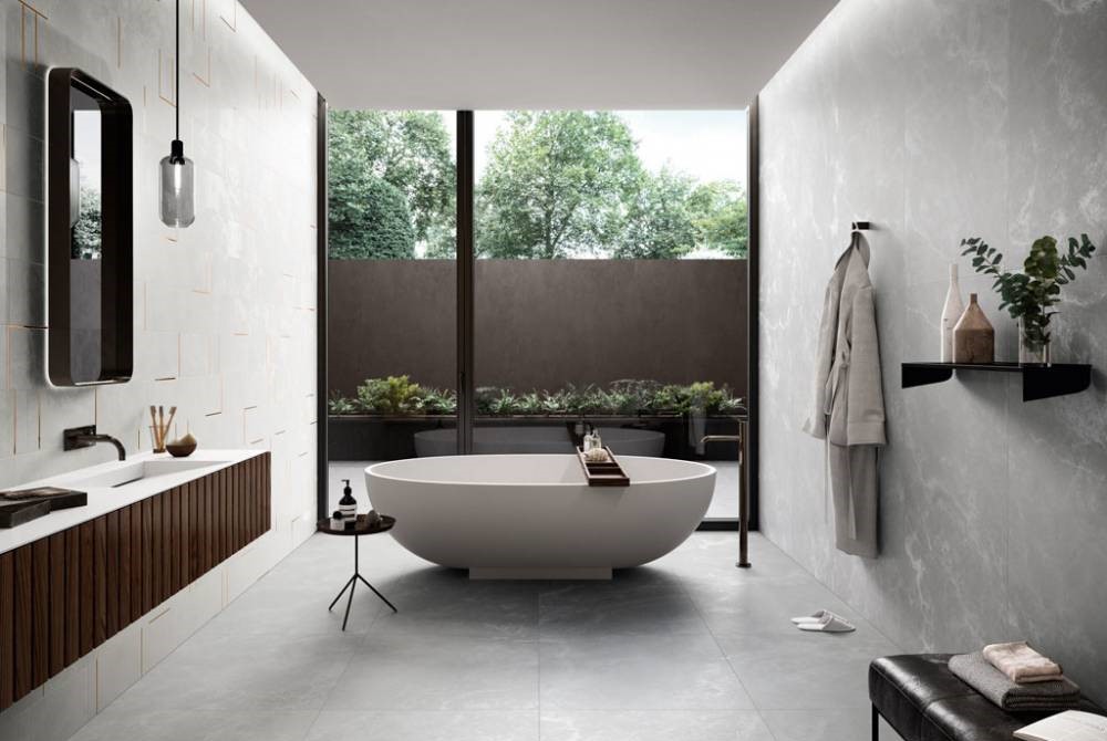 grey bathroom with white bathtub washbasin, mirror, shelf and pendant light