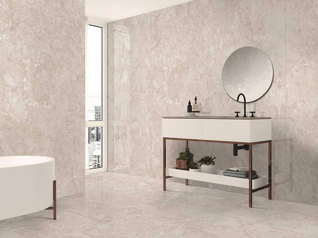 pink bathroom with white bathtub, washbasin and mirror