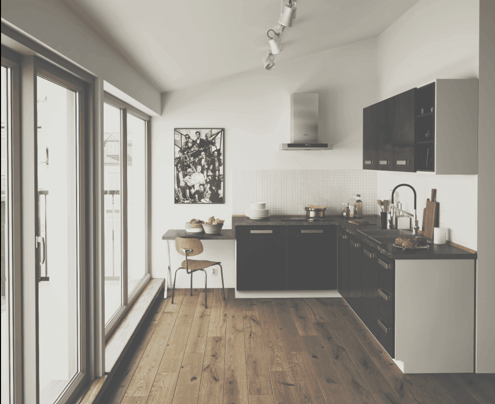 wooden flooring, glass sliding doors, black kitchen counters, small kitchen