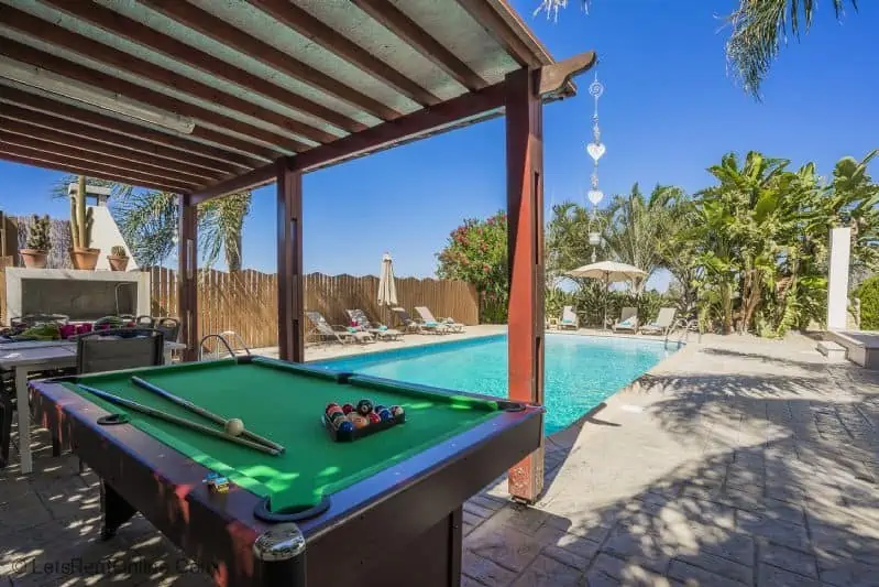Pool table in gazebo with swimming pool view