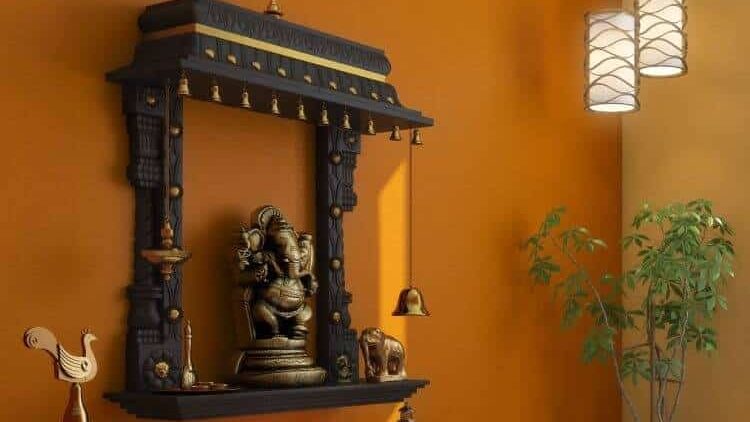 black mandir with idol, plants and decorative items