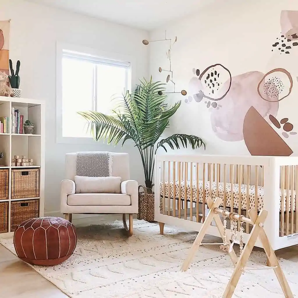 nursery with wooden crib, sofa, bookshelf and patterned kitchen or living room wall sticker