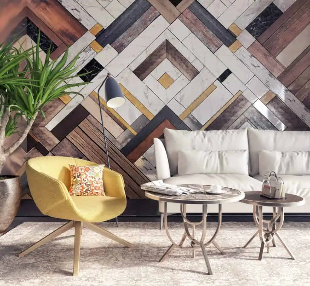 Yellow armchair in a living room with white couch and an attractive geometric wall pattern.