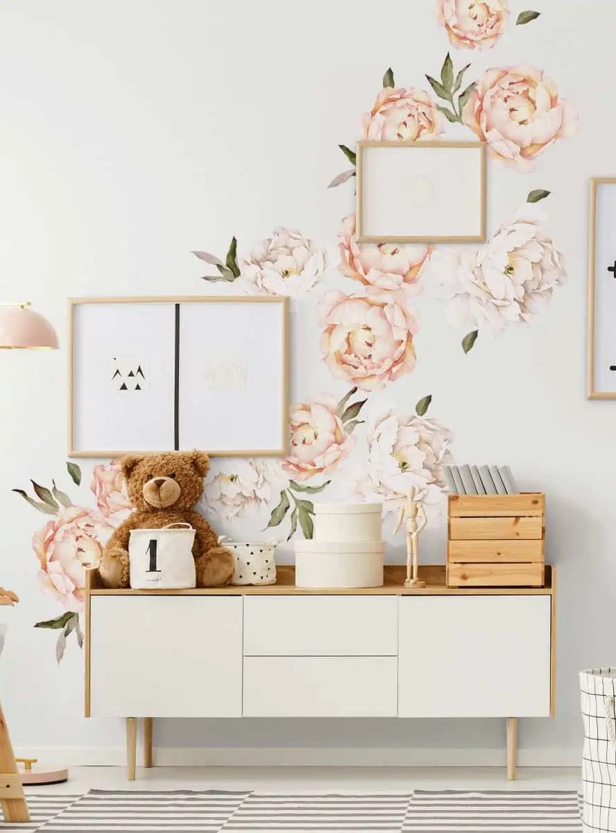 Picture frames and wooden furnishing in a bedroom.