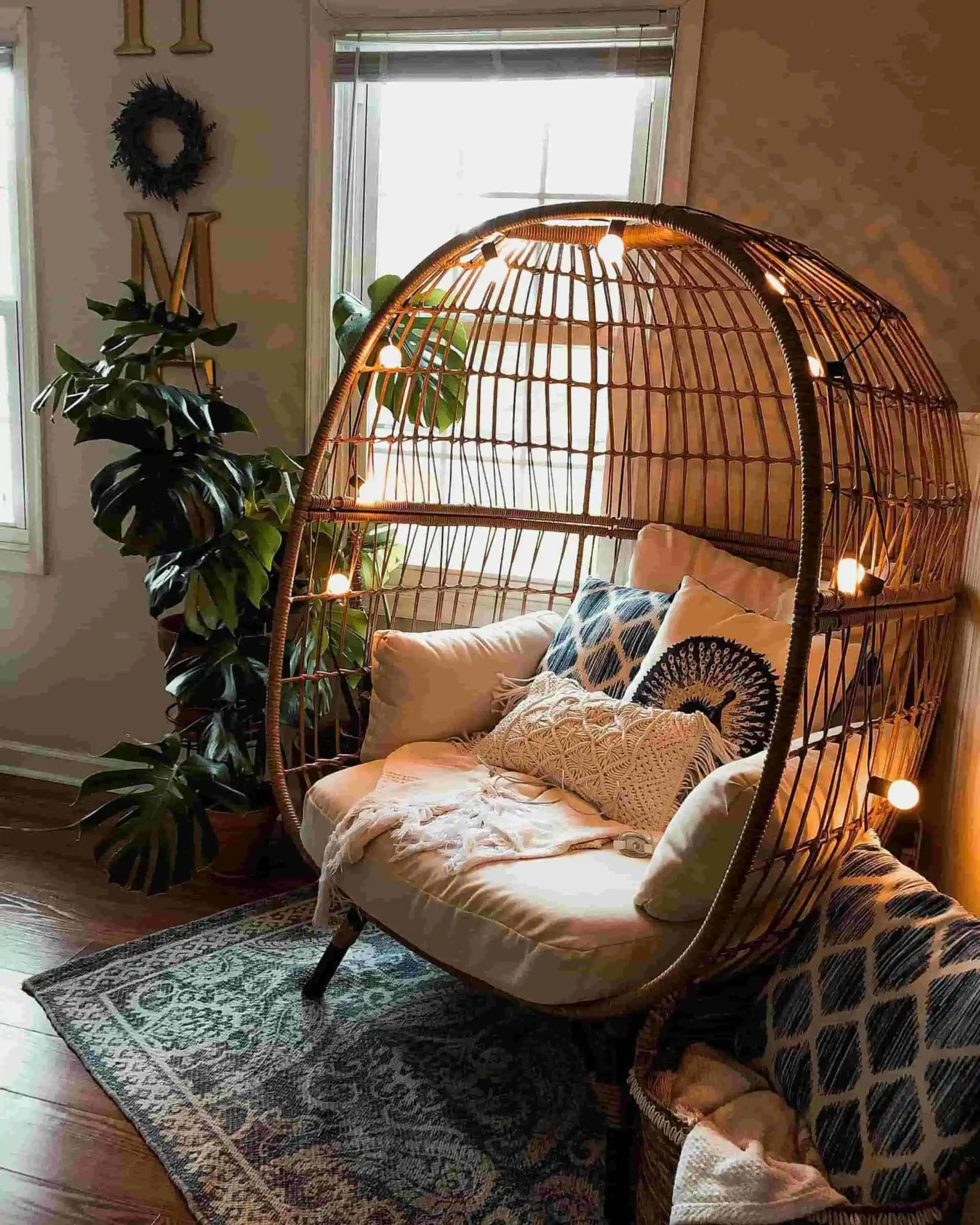 Eccentric egg design with bulb decoration, cushions, house plants and a patterned rug.