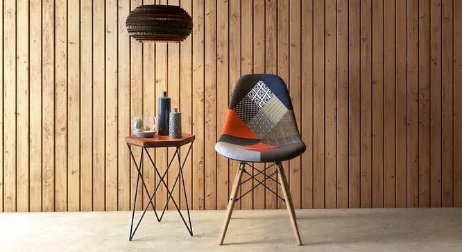 A plastic chair with wooden legs and fabric upholstery set against a wooden wall complementing a wooden stand. 