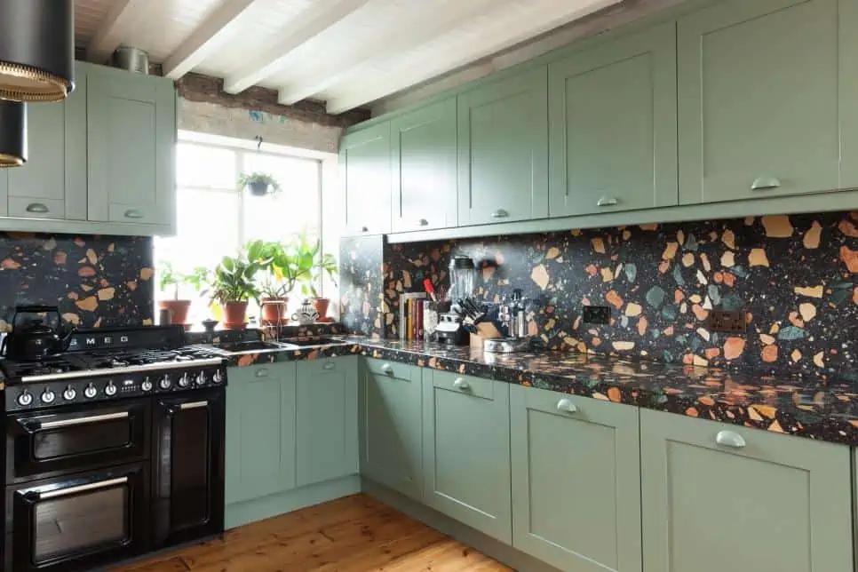 black terrazzo tiles for kitchen walls with green cabinetry