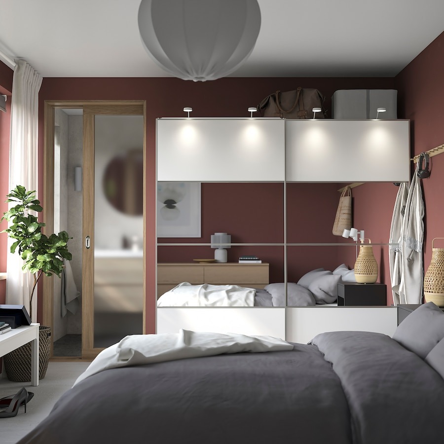 sliding door wardrobe with mirrors in a bedroom with grey bedding