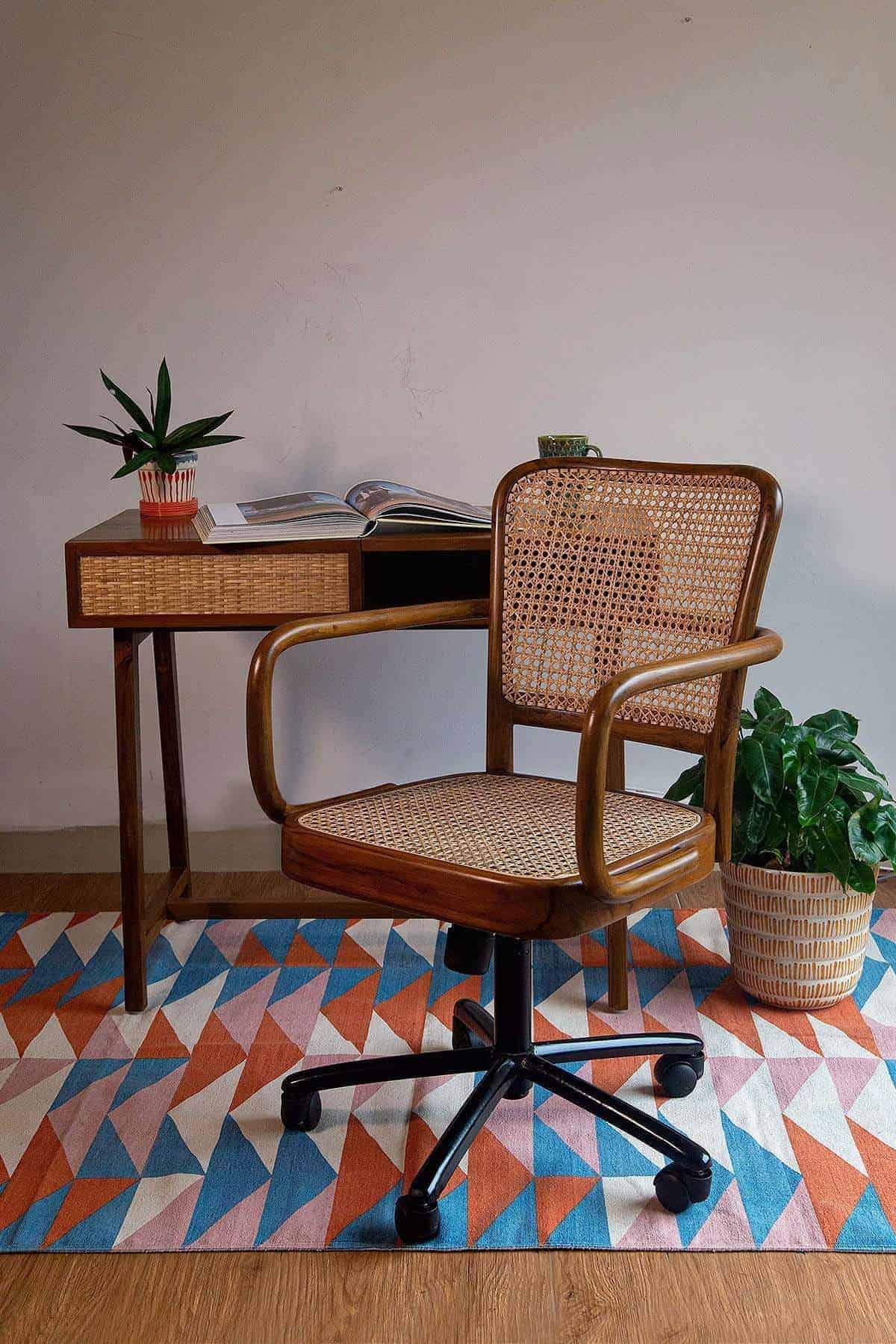 wicker study station with wooden flooring and patterned rug, wood office chair with plastic wheels