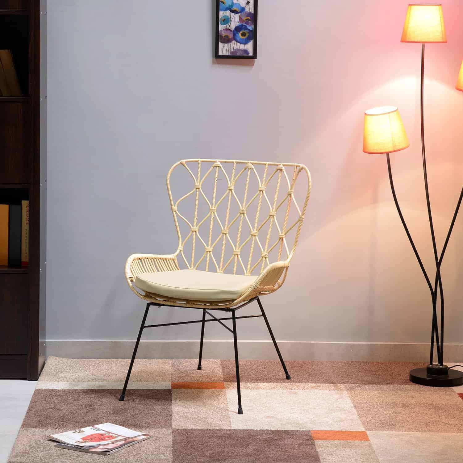 Beautiful white rattan chair placed in a home setting over a multicolored rug complementing a black metal lamp