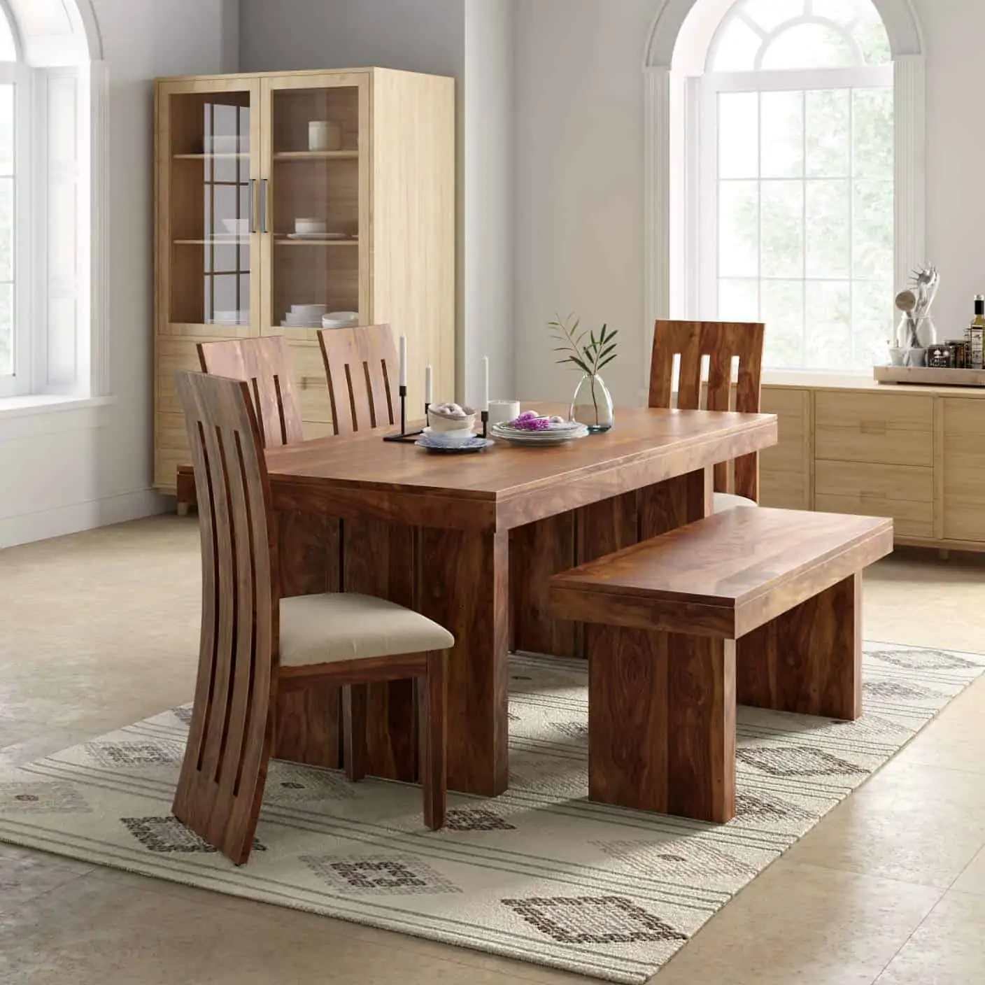 Wooden polished dining table set with wooden bench and 4 chairs, with off white seating, in a room with cabinets