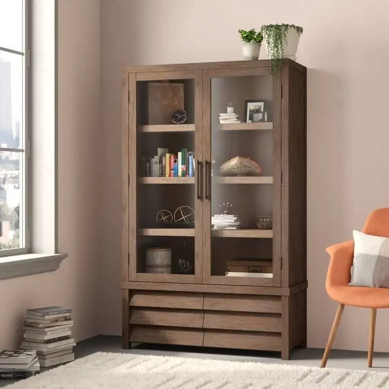 brown wooden antique cupboard, glass panels, light pink walls, orange chair, window