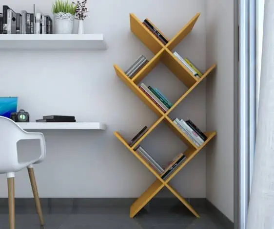 yellow angular bookshelf with books arranged, corner of the room with study table