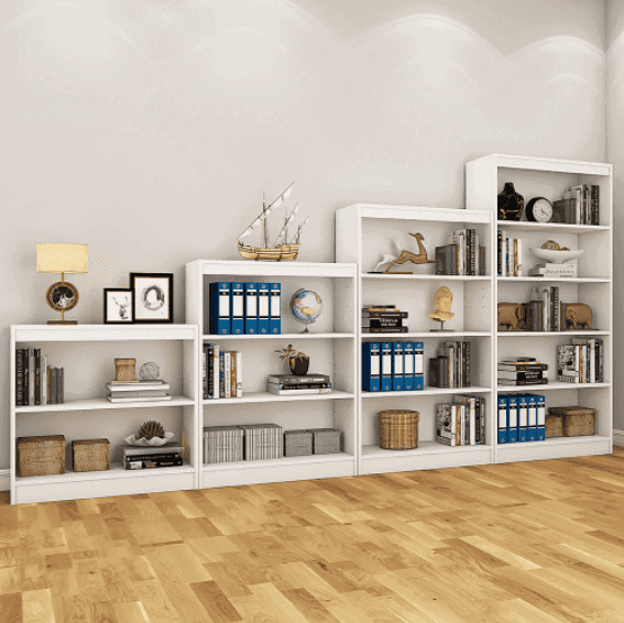 white large bookshelf step shaped, table like, off white walls, books and articles