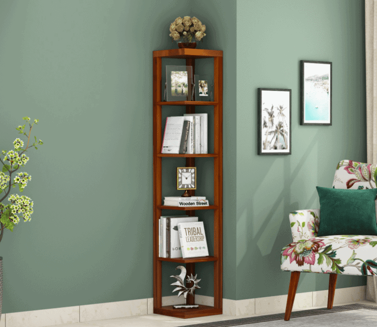 corner angular book stand, brown, green walls, room setting, books, showpieces, sofa, table
